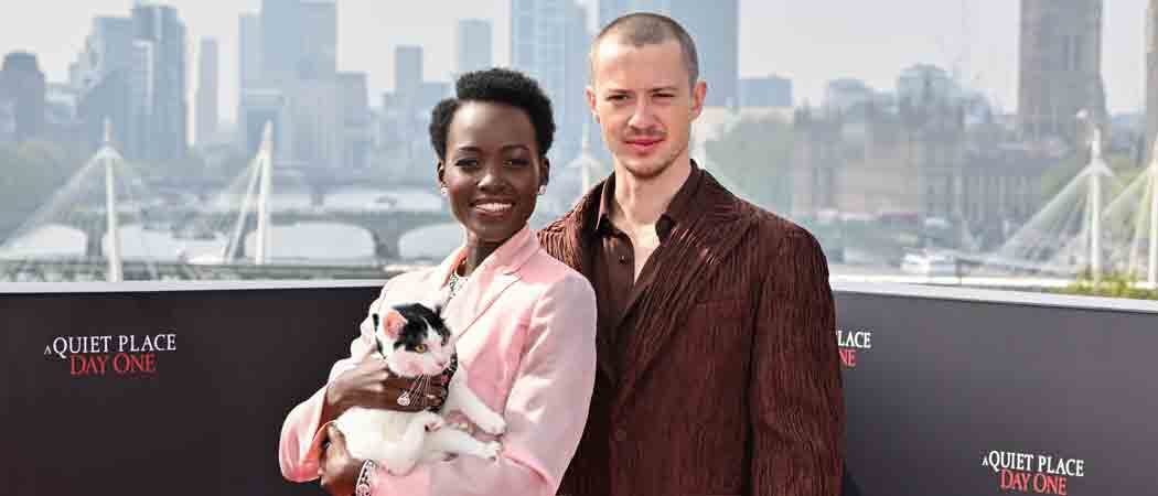 Lupita Nyong Holds A Cat While Posing With ‘Quiet Place’ Costar Joseph Quinn In London