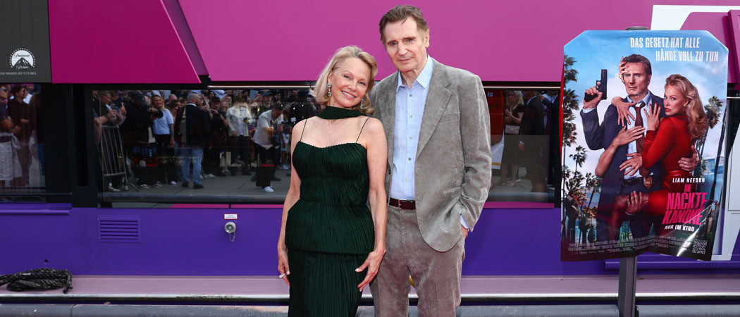 Liam Neeson & Makeup-Free Pamela Anderson Share Kiss At ‘Naked Gun’ Premiere: ‘I’m Madly In Love With Her!’